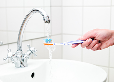 Rinsing toothbrush under tap - slideshow